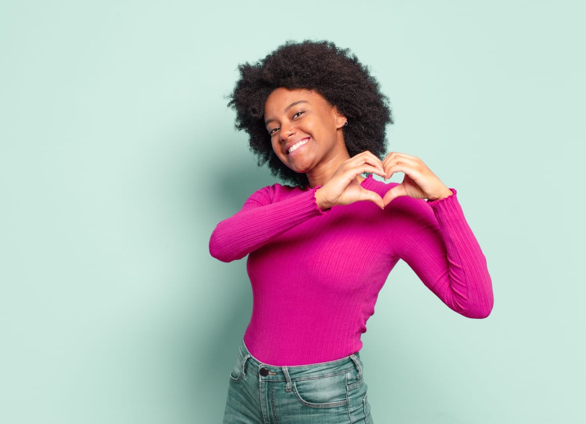 woman making a heart with her hands