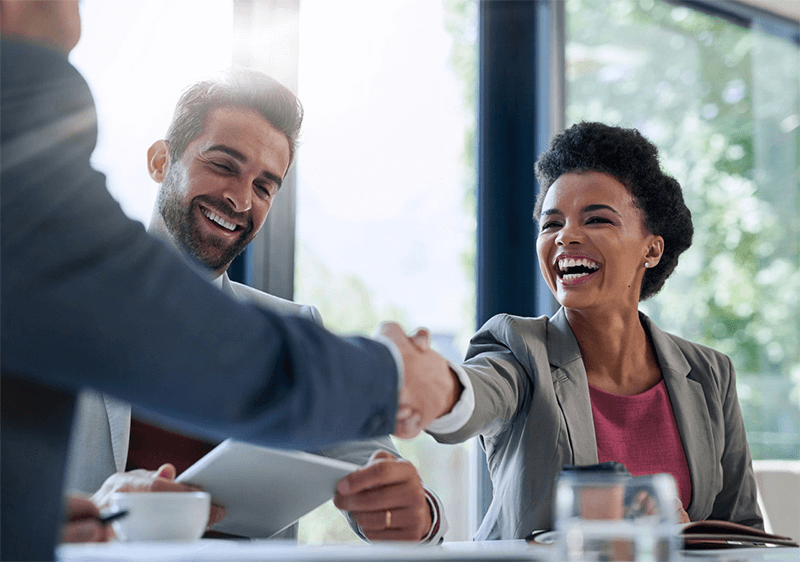 Two office workers shaking hands