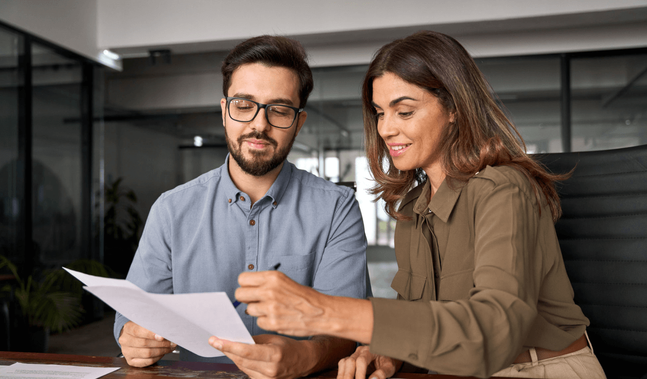 Two office workers looking at paperwork