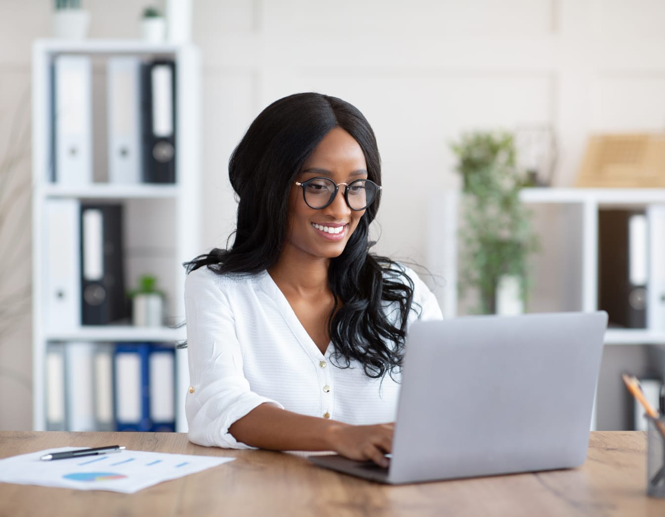 Girl with glasses using a laptop