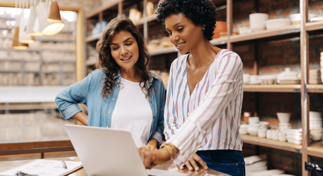 Two woman looking at a laptop