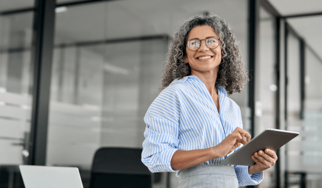 Smiling woman holding a tablet